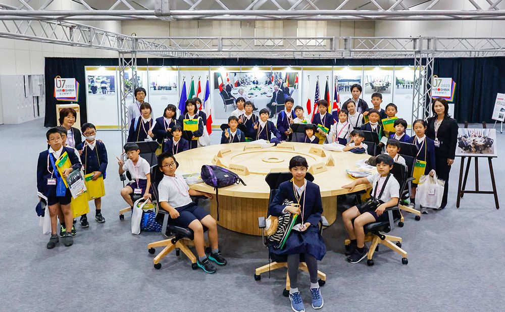 Children encircle the G7 round table