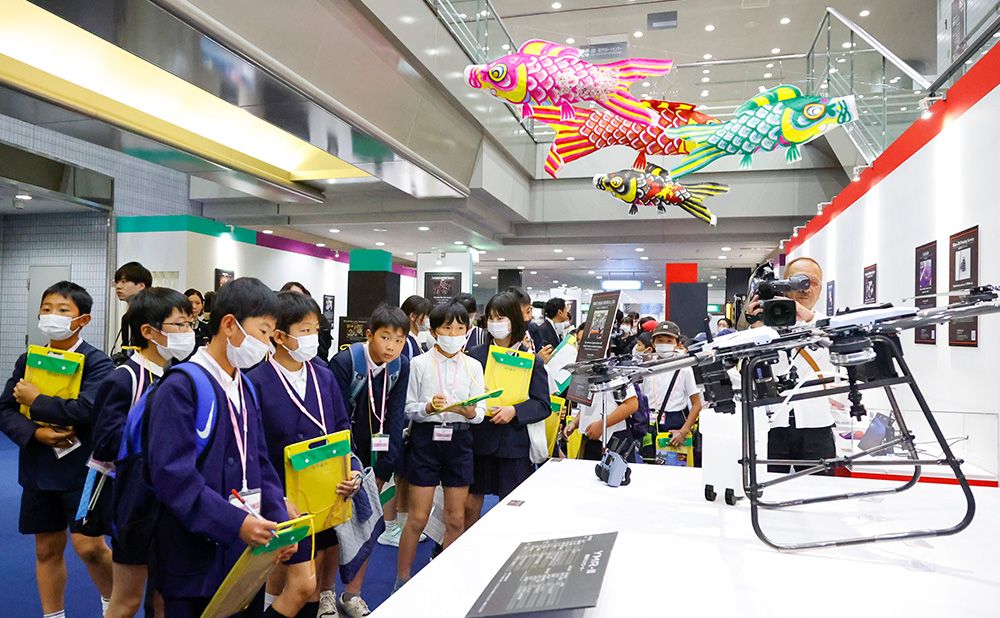 Children inspect the drone display