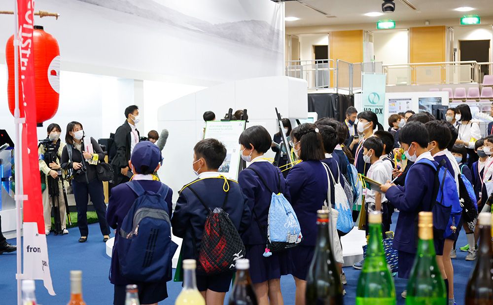 Children look the Reconstruction Agency booth