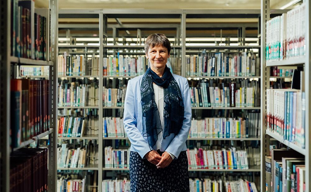 Carolyn Funck standing in front of the library collection.