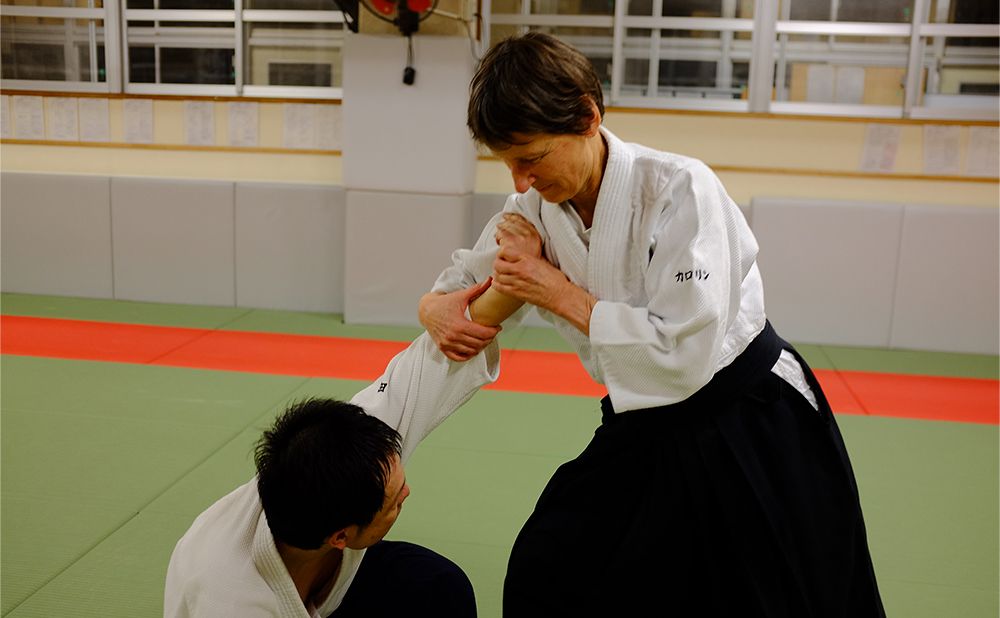Funck taking her opponent's wrist in aikido.