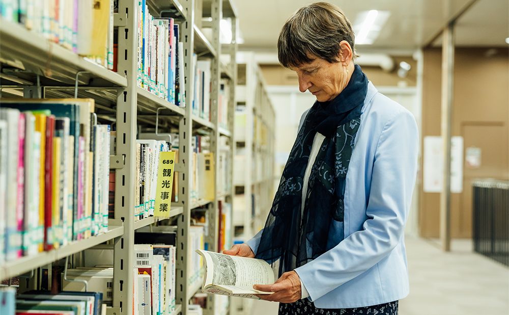 Funck reading a book in the library collection