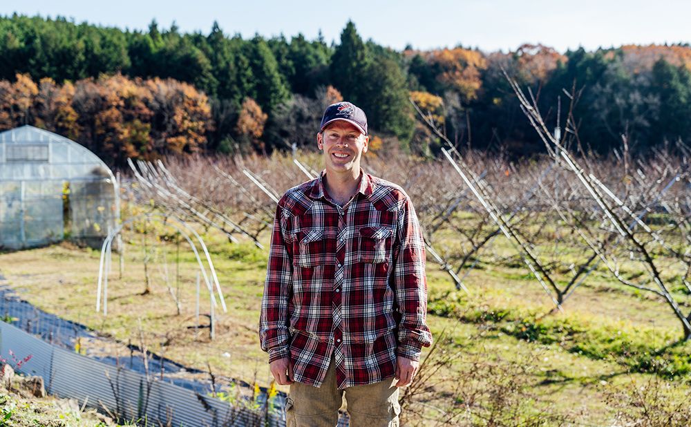 Lapierre smiling in front of the field where he grows his own crops