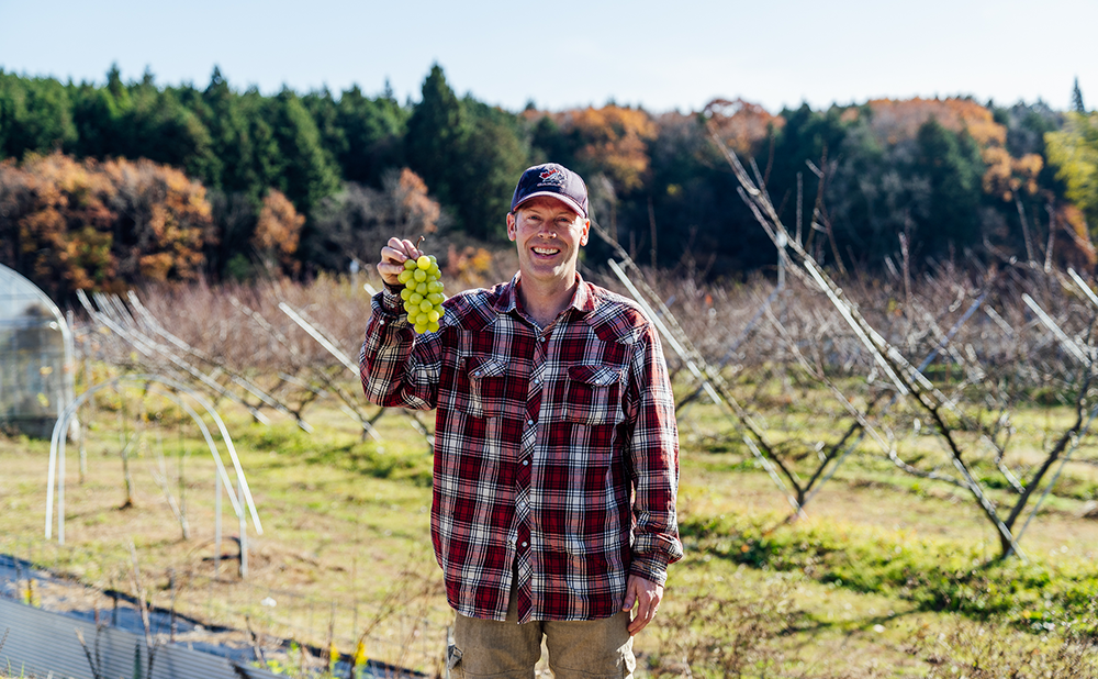 Lapierre smiling as he holds his own grapes