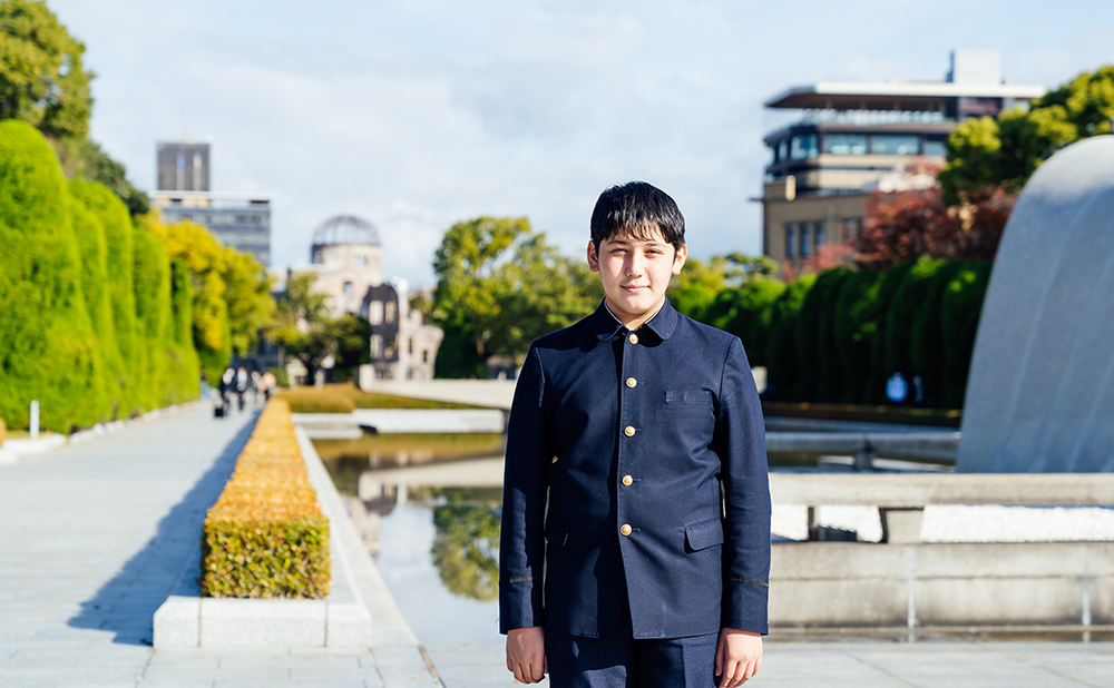 Alex standing in front of the Cenotaph for the Atomic Bomb Victims in Peace Memorial Park
