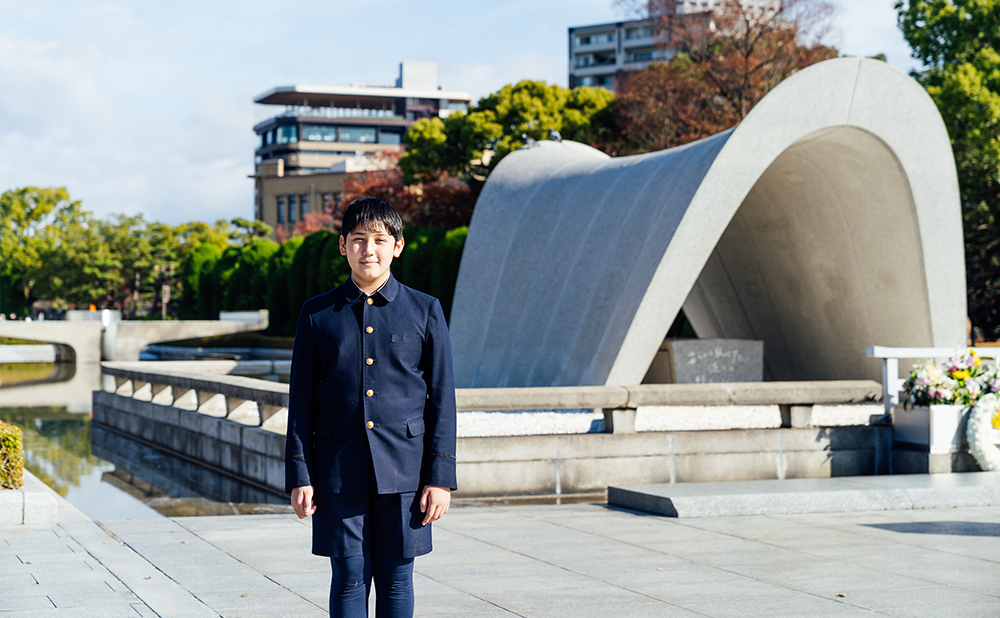 Alex standing in front of the Cenotaph for the Atomic Bomb Victims in Peace Memorial Park